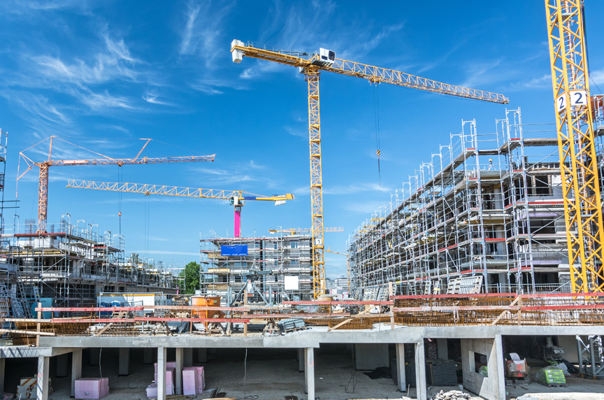 Hammerhead and Luffing Boom Tower Cranes at a Construction Site