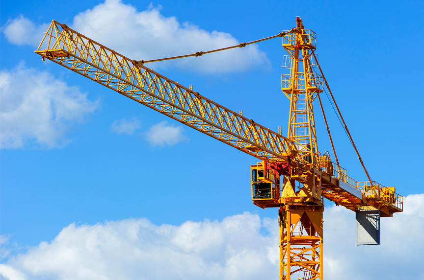 Tall Tower Crane in the Sky with Clouds Behind Preparing for a Lift