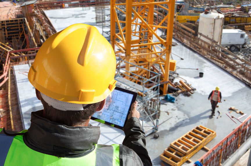 Site Supervisor looks over plans for construction and tower crane lifts